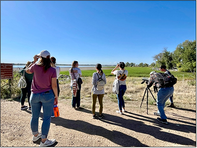 2024-09-28_blue_conservancy_birding_event_400px.png group of individuals watching birds outdoors