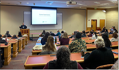 2025-01-29_Farm-Sanctuary_400px.png speaker at podium addressing participants in classroom
