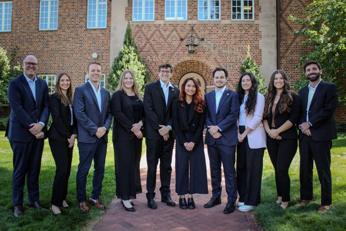 Group photo of CEDC faculty and student attorneys in front of building on DU campus