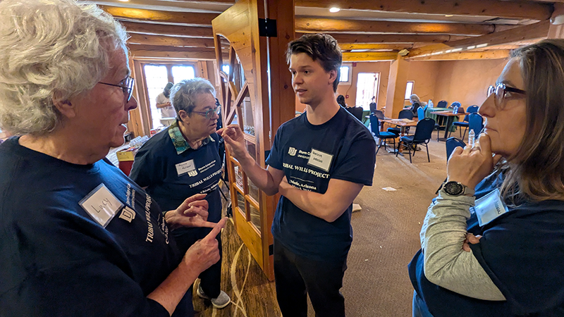 three individuals standing and talking
