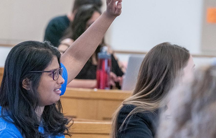 Female law student raising hand