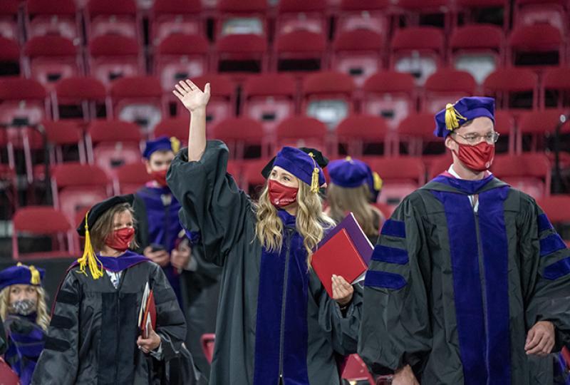 Student waving during law commencement